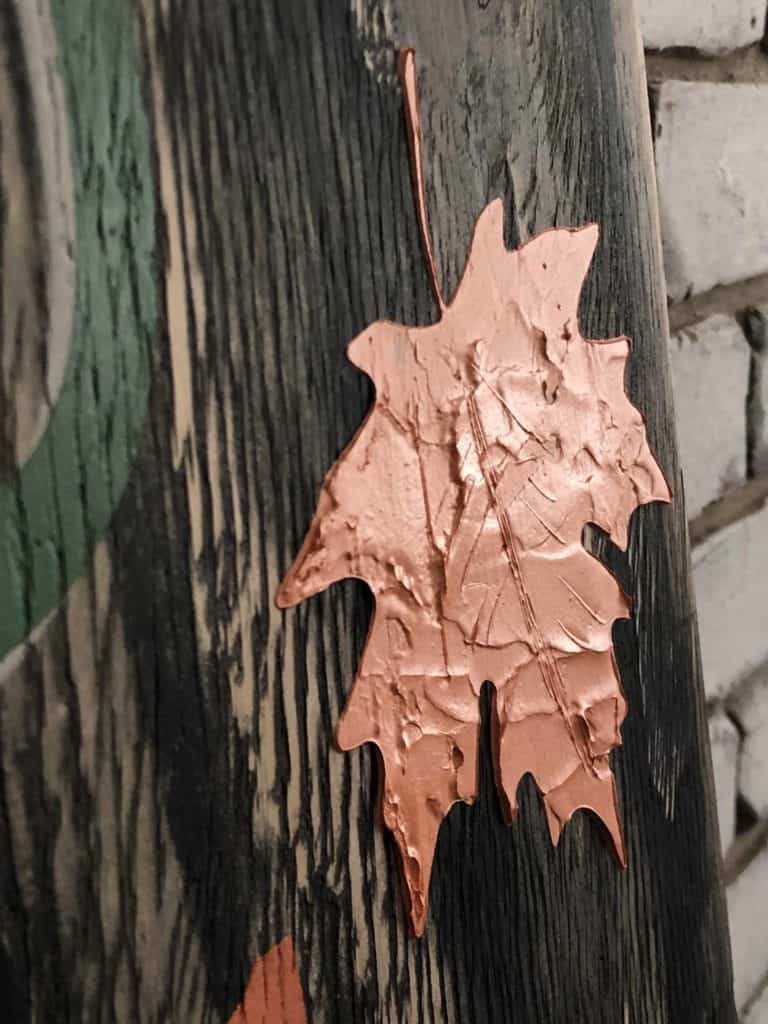 Embossed leaf stencil on Autumn sign.