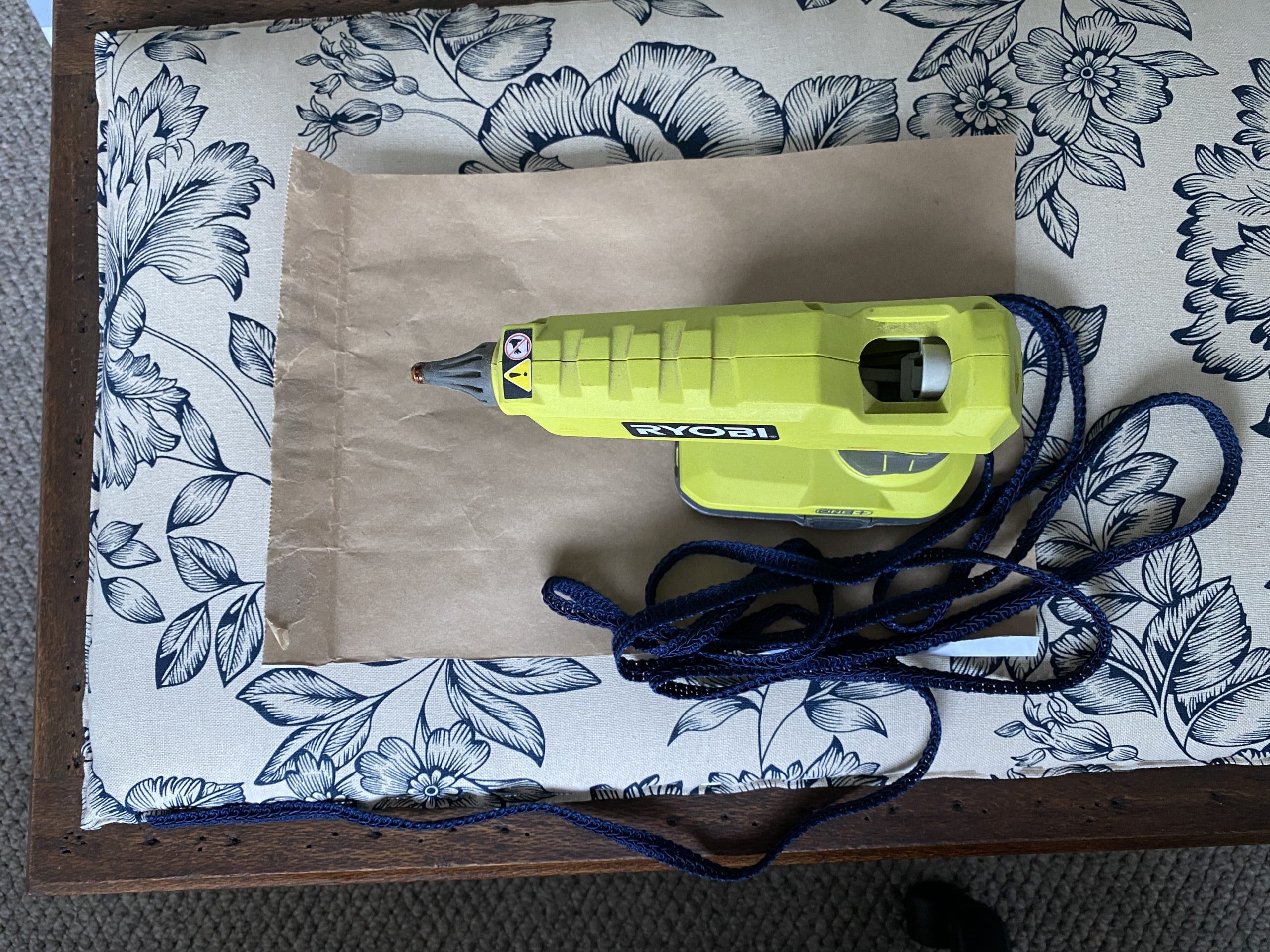 Ryobi hot glue gun on upholstery for box